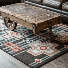 an old wooden table sitting on top of a rug