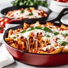 two pans filled with pasta covered in sauce and cheese