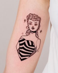 a woman's arm with a black and white tattoo design on the left forearm