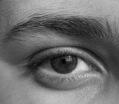 a man's eye is shown in black and white