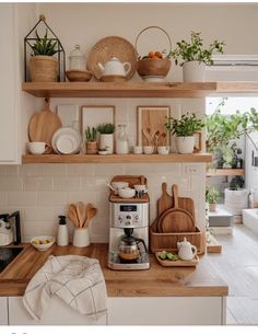 the kitchen counter is covered with wooden utensils and cutting boards, pots and pans