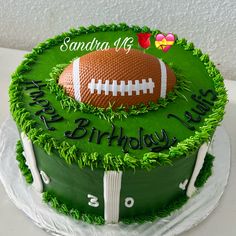 a green birthday cake with a football on it