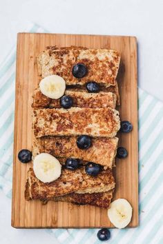 french toast sticks with bananas and blueberries on a cutting board