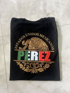 Show off your Mexican pride with this custom made Mexico shirt. May be personalized with a name of your choosing or a preferred state name.  If you need your item by a certain date please contact me so that we can work with you. If you have any problem with your order please feel free to contact us. T-Shirt:  Gildan Soft Style G6400 Solid Colors:4.5 oz/sq yd, 100% Ring Spun Cotton  Heathered Colors: 65% poly/35% cotton, Sport Grey 90%cotton/10%poly T-Shirt Care: Wash in cold cycle, inside out, n Fan Merchandise Tops With Custom Logo And Crew Neck, Fan Merchandise Crew Neck Tops With Custom Logo, Mexican Names, Mexican Eagle, Mexican Pride, Mexico Shirt, Mexican Shirt, Mexico Shirts, Mexican Shirts