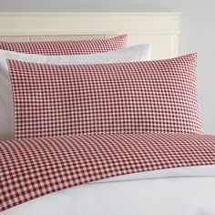 a red and white checkered bed with pillows