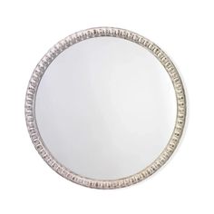 a round mirror with silver trim around it