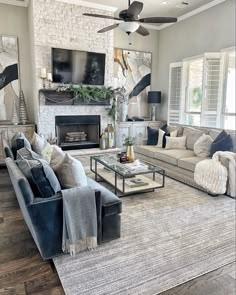 a living room filled with furniture and a flat screen tv mounted on the wall above a fireplace