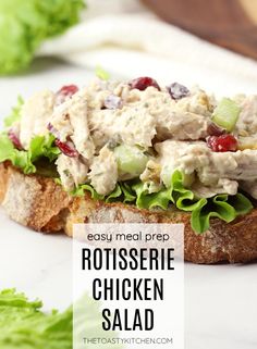 a chicken salad sandwich with lettuce and cranberries on it is shown