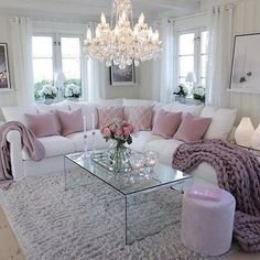 a living room filled with furniture and a chandelier