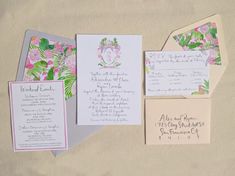 the wedding stationery is laid out on the sand