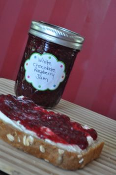 a jar of jam sitting on top of a piece of bread