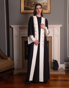 Step into elegance with this sophisticated black and white abaya, meticulously designed for the modern woman who appreciates unique details. The abaya features striking gold accents and pearl embellishments, making it a standout piece in your wardrobe. Crafted from high-quality fabric, this abaya offers both comfort and style, perfect for special occasions or everyday wear. The flowing design and modest cut ensure it complements all body types, providing a graceful and timeless look. Whether you Black And White Abaya, White Abaya, Black And Cream, Gold Accents, Favorite Things Gift, Modest Fashion, Modern Woman, Body Types, Custom Sizing