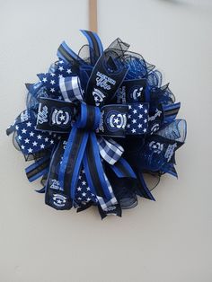 a blue and white football wreath on the wall