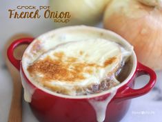 a close up of a cup of food on a table next to an onion and garlic