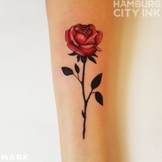 a small rose tattoo on the leg