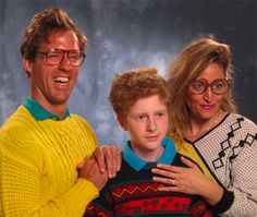 a man, woman and child posing for a photo