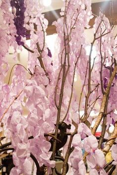 a vase filled with purple flowers on top of a table