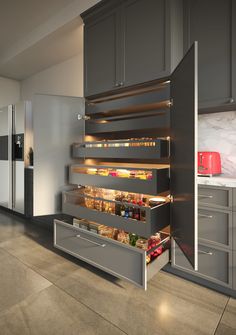 an open drawer in the middle of a kitchen