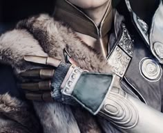 a close up of a person wearing armor and gloves