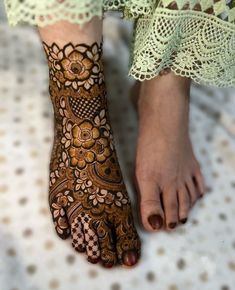 a woman's feet with hennap on it