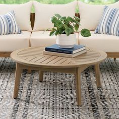 a living room with couches, coffee table and books on top of the tables