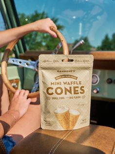 a bag of coffee sitting on top of a car seat next to a steering wheel