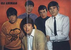 the beatles are posing for a photo in front of an orange background with black and white lettering