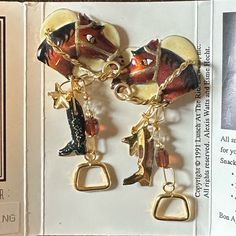 A Fabulous Vintage Lunch At The Ritz 3-D Earrings. This Elegant Equestrian Theme Piece Features A Chestnut Horse's Head With Gold Bridle, Riding Boots, And Gold Stirrups. Sparkling Swarovski Crystals, A Gold Star, And Austrian Beads Add Glamour To The Earrings. The Earrings Are Stamped "Lunch At The Ritz" And It Is In Perfect Condition, Never Been Worn In Original Package. Latr's Equestrian Theme Jewelry Is Very Difficult To Find And Is Highly Collectible. Perfect For Latr Collectors And Equestrians. Latr Designs Are Blends Of Resins, Australian Crystal, Czechoslovakian Glass And Semi Precious Beads. Measures About: Length 2.5 Inches, Width 1.25 Inches. Note: Latr Was Founded In 1982 By T Vintage Lunch, Precious Beads, Chestnut Horse, Family Jewels, The Ritz, Semi Precious Beads, Stirrups, Gold Star, Horse Head