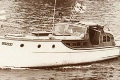 an old photo of a boat in the water with flags on it's mast