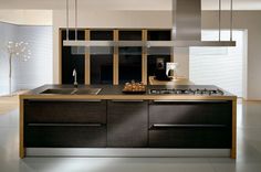 a modern kitchen with stainless steel appliances and wood cabinets