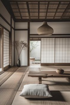 an empty room with tatami mats and pillows