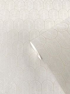 a white wallpaper with an intricate design on the side and a light shining through it