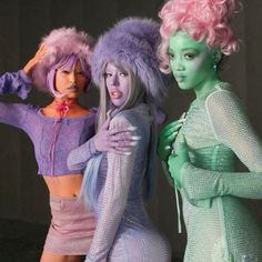 three women dressed in costumes posing for the camera