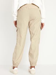 elastic-drawstring waist faux fly front pockets flap-cargo pockets at thigh side-zip hem elasticized cuffs sits at belly button loose hip and thigh tapered leg hits at ankle 29" regular inseam 27" petite inseam 32" tall inseam models are approx.  5'9" and wear sizes s (4), l (12), and xl (18)machine wash according to the care instruction label Tan Cargo Pants, Pajamas Gift, Cargo Joggers, Family Maternity, Family Pajamas, Jack Black, Old Navy Women, Navy Women, Petite Size