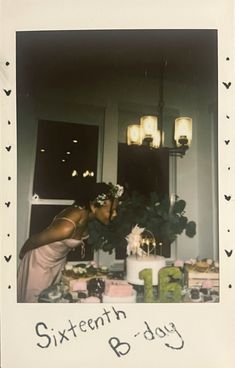 a woman standing in front of a table with cake and flowers on it's head