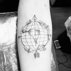 a black and white photo of a world map tattoo