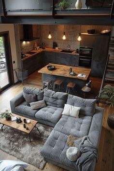 a living room filled with furniture next to a kitchen and an open concept floor plan