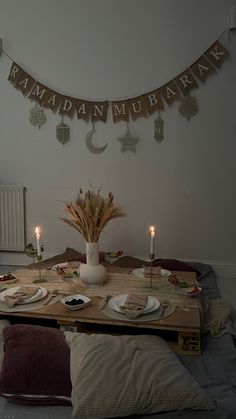 the table is set with plates and candles