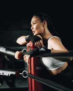 a woman is sitting in the ring with her boxing gloves on