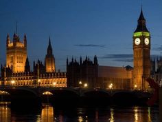 the big ben clock tower towering over the city of london, england at night time