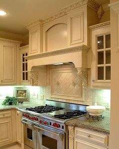 a kitchen with an oven, stove and cabinets in it's center island area