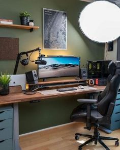 a desk with a monitor, keyboard and speakers on it