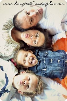 three adults and two children laying on top of each other