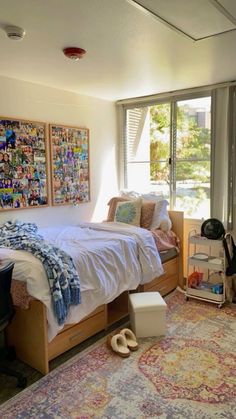 a bed room with a neatly made bed next to a window and a rug on the floor