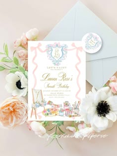 the wedding card is surrounded by flowers and an envelope with it's name on it