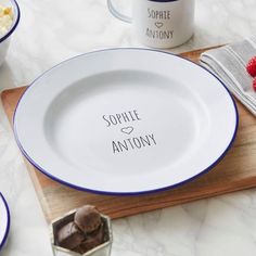 a couple of plates that are sitting on a table next to some cups and spoons