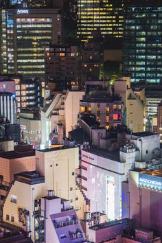 an aerial view of the city at night with buildings and skyscrapers in the background