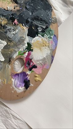 an art palette with paint and paper on it