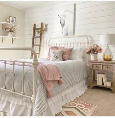 a bedroom with white walls and pink accents