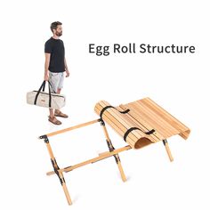 an egg roll structure with a man standing next to it and carrying a white bag